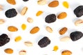A top-down shot shows a variety of nuts and dried fruit scattered on a white background Royalty Free Stock Photo