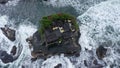 Top down Tanah Lot Temple on the rock in Sea. Ancient hinduism place of worship. Sunlight. Aerial view. Bali, Indonesia Royalty Free Stock Photo