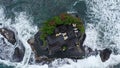 Top down Tanah Lot Temple on the rock in Sea. Ancient hinduism place of worship. Sunlight. Aerial view. Bali, Indonesia Royalty Free Stock Photo