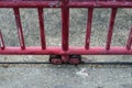 A top down veiw of an old rusty wheels of a sliding steel door with a red painted fence on a metal Royalty Free Stock Photo