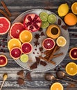 Top down view of an abstract collage of citrus fruits along with cinnamon, honey and chocolate.