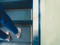 A top down view of an adult woman`s feet, seen standing on the way up an escalator, with copy space. Royalty Free Stock Photo