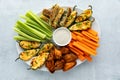 Top down view of an appetizer platter filled with homemade baked appetizers and crispy cold celery and carrots sticks. Royalty Free Stock Photo