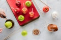Top down view of apples being prepared to make Halloween caramel apples. Royalty Free Stock Photo