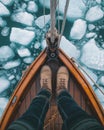 A top-down view of an Arctic explorer\'s feet on the deck of their old sailing ship. Generative AI. Royalty Free Stock Photo