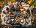 Top-down view of an autumn vineyard harvest lunch, featuring grilled quail, fig and walnut salad, a cheese platter with Royalty Free Stock Photo