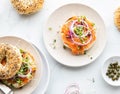 Top down view of a bagel topped with salmon lox and garnished with red onion, sprouts and capers. Royalty Free Stock Photo