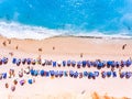 Top down view of a beach with tourists suntbeds and umbrellas wi Royalty Free Stock Photo