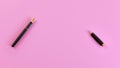 Top down view - black fountain ink pen with gold nib, opened, cap on the right, pink background, space for text Royalty Free Stock Photo