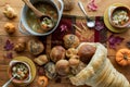 Top down view of bowls of turkey soup and a bread cornucopia with buns and rolls pouring out. Royalty Free Stock Photo