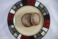 Top down view of browned sausage patties on saucer plate