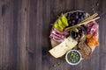 A Top down view of a charcuterie board filled with various healthy finger foods.