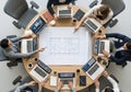 Top-down view of circular seating with open laptops and blueprint in center symbolizing aligned collaboration, mutual focus, and Royalty Free Stock Photo