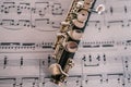 Close up of wooden flute on white sheet music Royalty Free Stock Photo