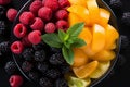Top down view of colorful fresh fruit salad in glass bowl on wooden table for healthy eating concept Royalty Free Stock Photo
