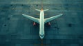 Top down view on commercial airplane docking in terminal in the parking lot of the airport apron, waiting for services Royalty Free Stock Photo