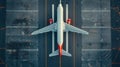 Top down view on commercial airplane docking in terminal in the parking lot of the airport apron, waiting for services Royalty Free Stock Photo