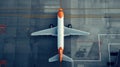 Top down view on commercial airplane docking in terminal in the parking lot of the airport apron, waiting for services Royalty Free Stock Photo