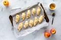 Top down view of crescent rolls with apple filling on a parchment lined baking sheet, ready for baking. Royalty Free Stock Photo