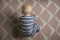 A top down view of a cute baby as they try to crawl on a carpet Royalty Free Stock Photo