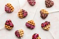 Top down view of decorated heart shaped waffle pops for Valentine's Day