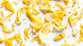 Overhead view of dried lemon zest pieces scattered on white surface showcasing citrus texture Royalty Free Stock Photo