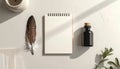 Top down view of a feather quill, ink bottle, notebook, and paper on a desk surface background Royalty Free Stock Photo