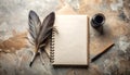 Top down view of a feather quill, ink bottle, notebook, and paper on a desk surface background Royalty Free Stock Photo