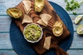 Top down view of a fresh bowl of homemade guacamole surrounded by tortilla chips Royalty Free Stock Photo