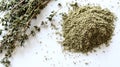 Top-down view of fresh thyme sprigs and ground thyme powder, displayed with soft lighting. Royalty Free Stock Photo