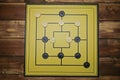 Top down view on gameboard with black and white pieces of strategy game for two people - nine men`s morris or mills