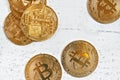 Top down view, golden commemorative BTC - bitcoin cryptocurrency - coins scattered on white stone board, closeup detail