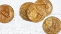 Top down view, golden commemorative btc - bitcoin cryptocurrency - coins scattered on white stone board, closeup detail