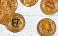 Top down view, golden commemorative btc - bitcoin cryptocurrency - coins scattered on white stone board, closeup detail