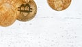 Top down view, golden commemorative btc - bitcoin cryptocurrency - coins on white stone board, closeup detail, space for text down