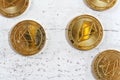 Top down view, golden commemorative EOS - EOSIO cryptocurrency - coins scattered on white stone board