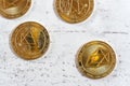 Top down view, golden commemorative EOS - EOSIO cryptocurrency - coins on white stone board