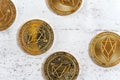 Top down view, golden commemorative EOS - EOSIO cryptocurrency - coins on white stone board