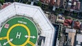 Top down close up view of helicopter landing pad on the roof of modern skyscraper in Jakarta city