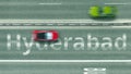 Top down view of the highway with revealing Hyderabad text. Driving in Pakistan 3D rendering