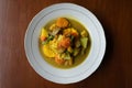 Top down view of a Indonesian Sayur Kare (Balinese Vegetable Curry) on white plate