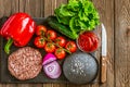 Top down view of ingredients for beef black burger on a black stone board with knife. Delicious food Royalty Free Stock Photo