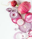 A top down view of a macro abstract arrangement of red onion slices with daikon and radishes.