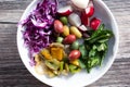 top down Mediterranean veggie medley plate, salad, olive, cabbage, radish, mint