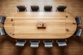 top-down view of a meeting table surrounded by chairs in an office or corporate environment.