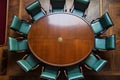 top-down view of a meeting table surrounded by chairs in an office or corporate environment.