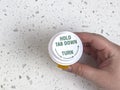 Top down view of a person holding a pill bottle against a white counter top Royalty Free Stock Photo