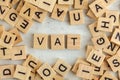 Top down view, pile of square wooden blocks with letters VAT stands for Value added tax on white board