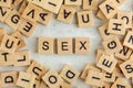 Top down view, pile of square wooden blocks with word SEX on white board Royalty Free Stock Photo