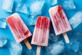 Top down view of popsicles and ice cubes against blue backdrop Royalty Free Stock Photo